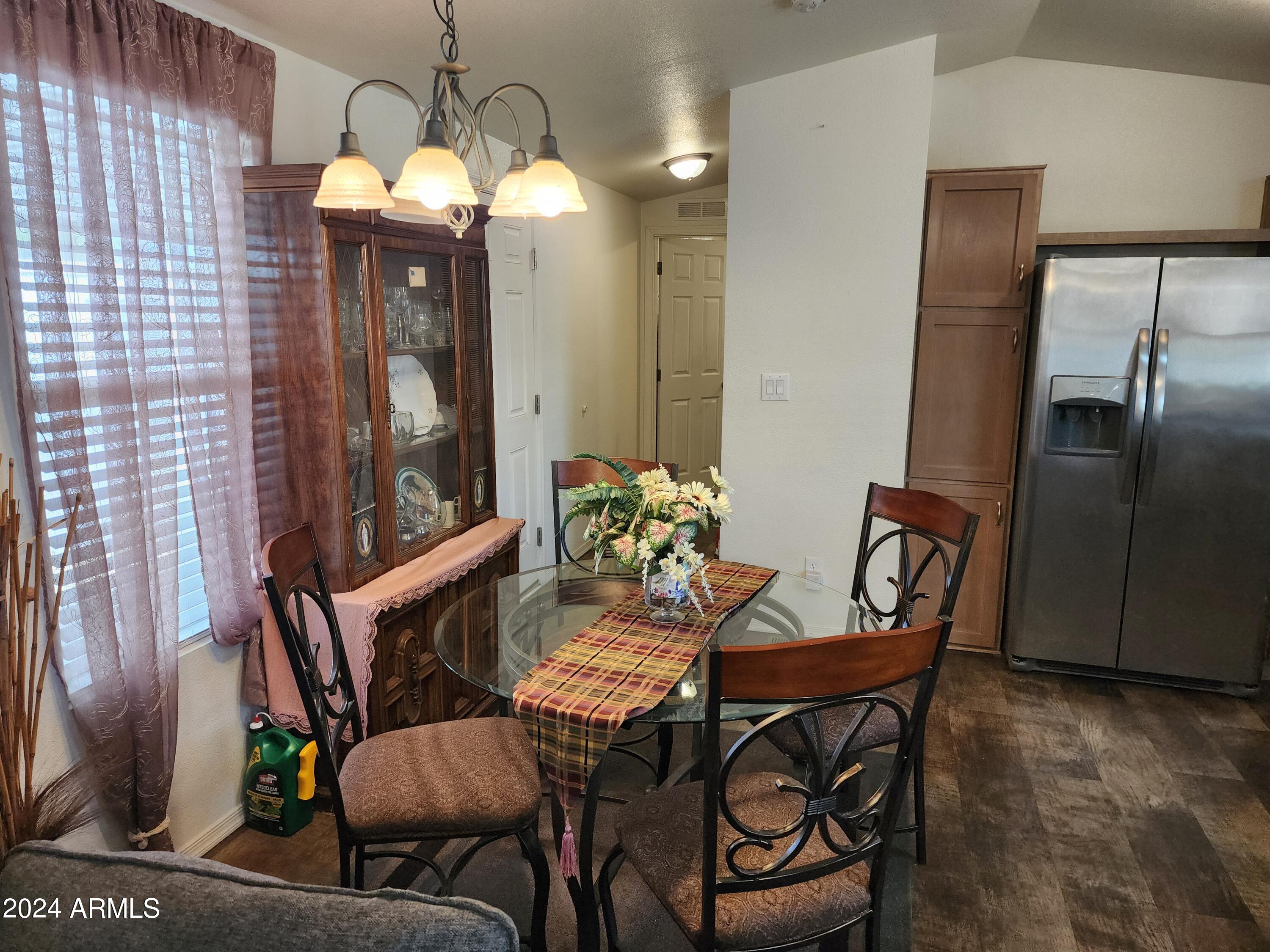 16005 North 32nd Street, Unit 31 Phoenix, AZ 85032 - Photo 4 of 48 a view of a dining room with furniture and a chandelier