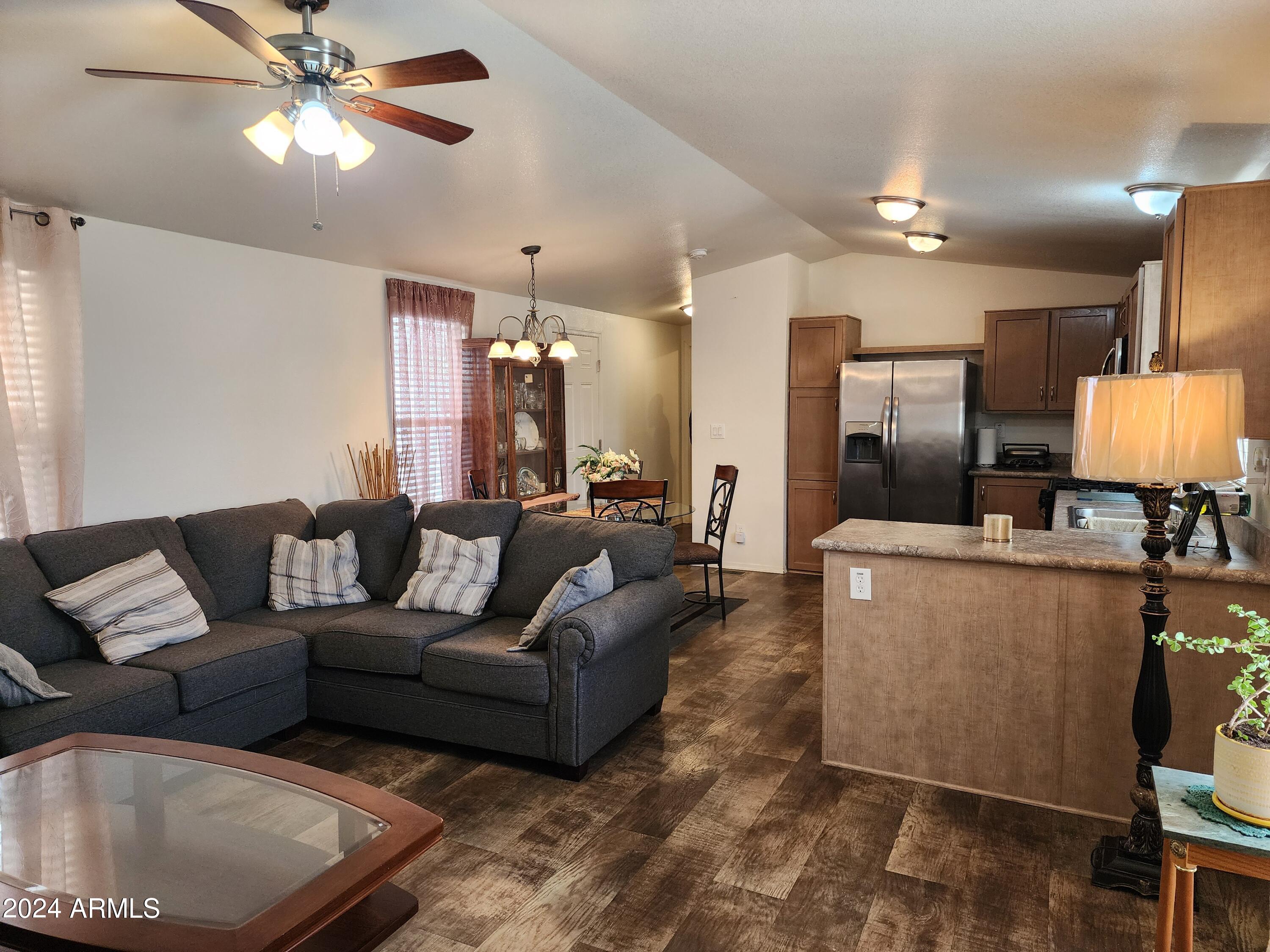 16005 North 32nd Street, Unit 31 Phoenix, AZ 85032 - Photo 7 of 48 a living room with furniture and a chandelier