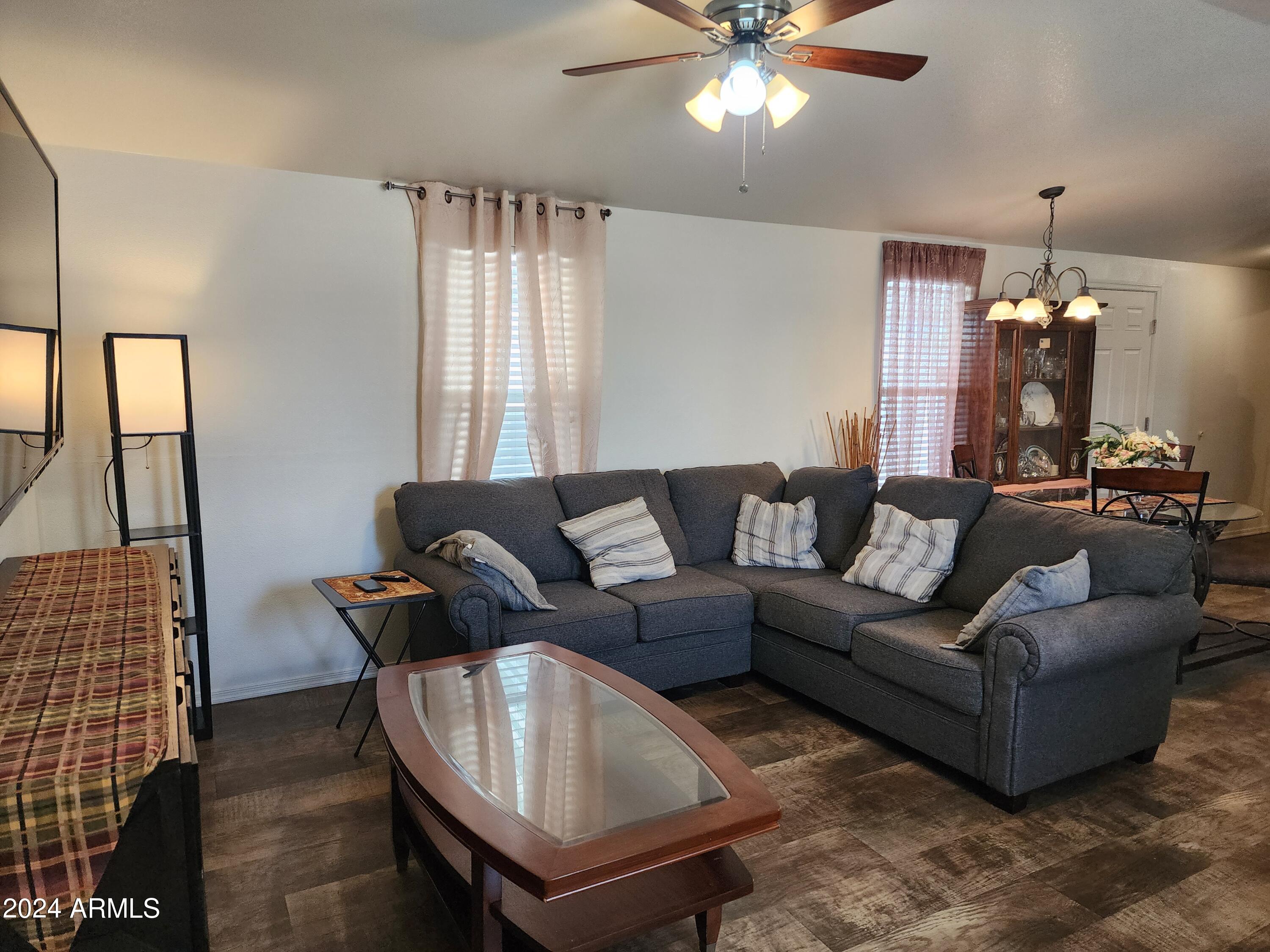 16005 North 32nd Street, Unit 31 Phoenix, AZ 85032 - Photo 8 of 48 a living room with furniture and a chandelier