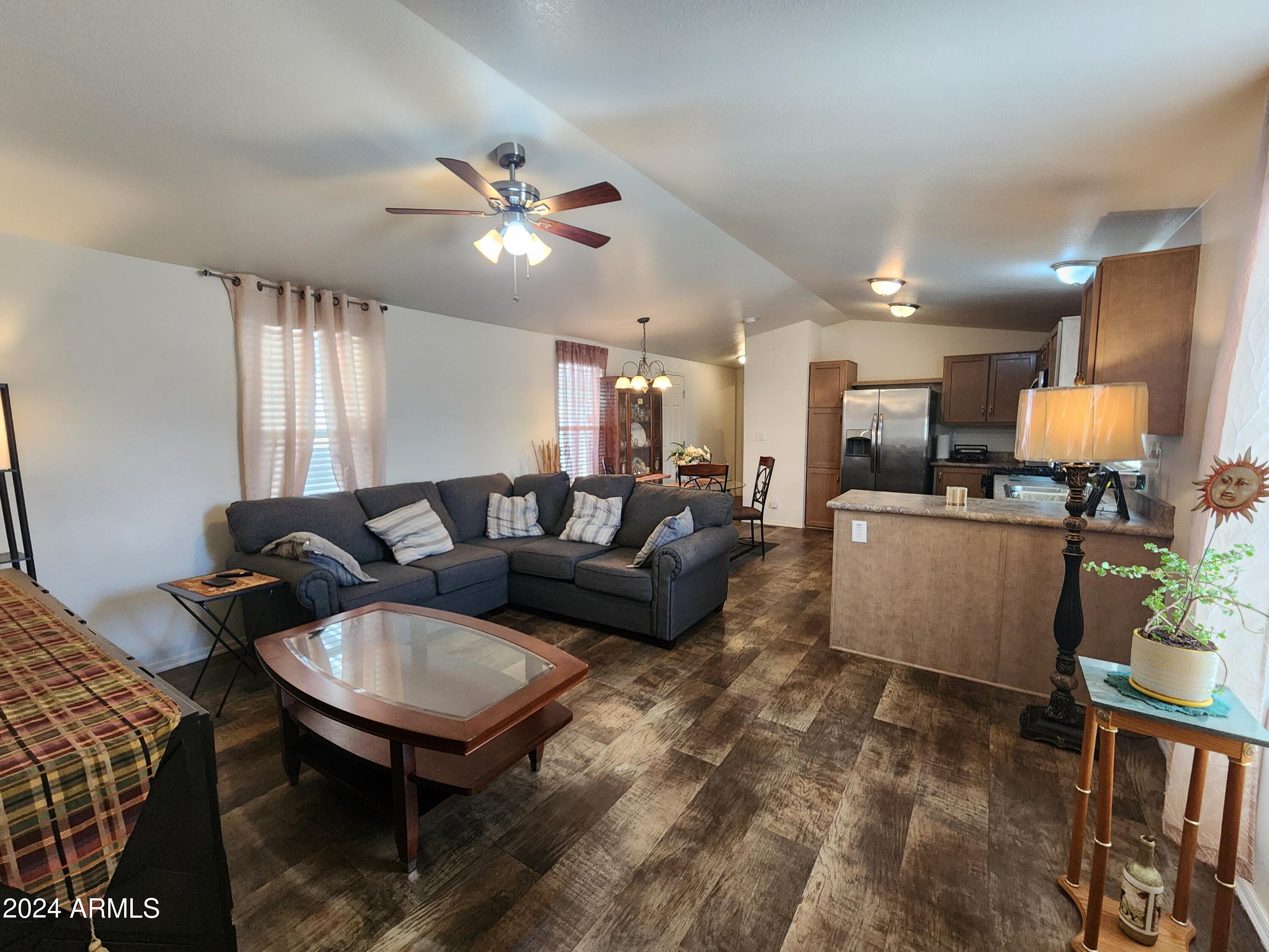 16005 North 32nd Street, Unit 31 Phoenix, AZ 85032 - Photo 10 of 48 a living room with furniture and kitchen view