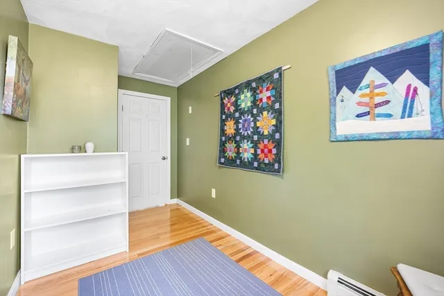 a view of a house with potted plants and a table and chairs