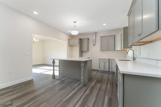 a kitchen with kitchen island cabinets and wooden floor