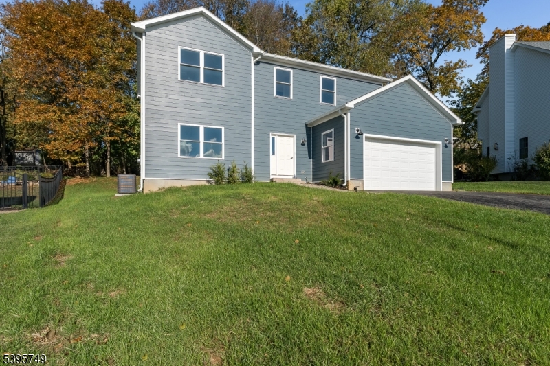 9 Heather Hill Road Washington, NJ 07882 - Photo 2 of 29 a front view of a house with a yard and garage