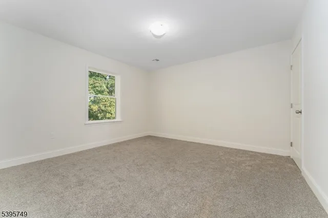 an empty room with a empty space and windows
