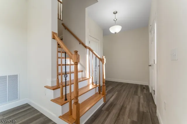 a view of entryway with stairs and wooden floor