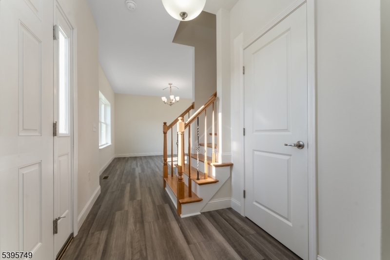 9 Heather Hill Road Washington, NJ 07882 - Photo 6 of 29 a view of a hallway with wooden floor and staircase