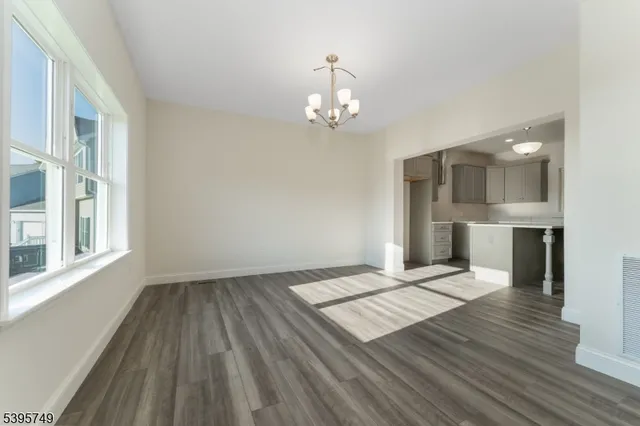 a view of livingroom with hardwood floor and a kitchen