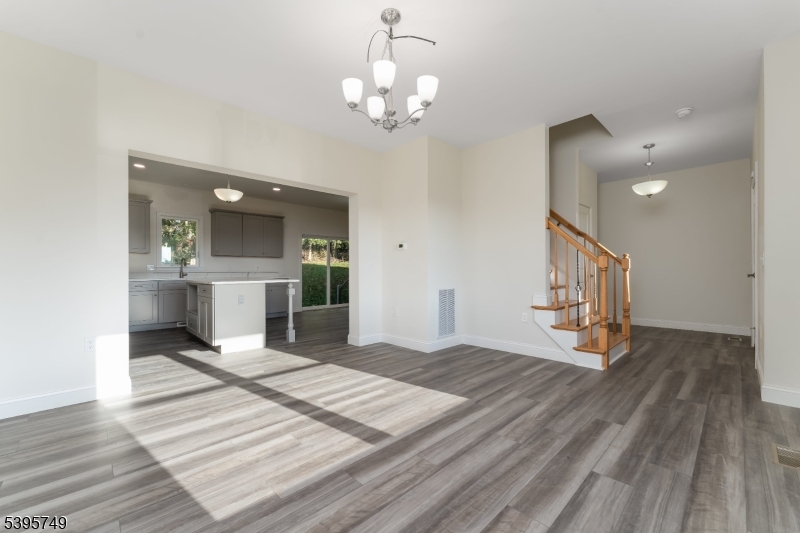 9 Heather Hill Road Washington, NJ 07882 - Photo 9 of 29 a view of a hallway with wooden floor and a kitchen space