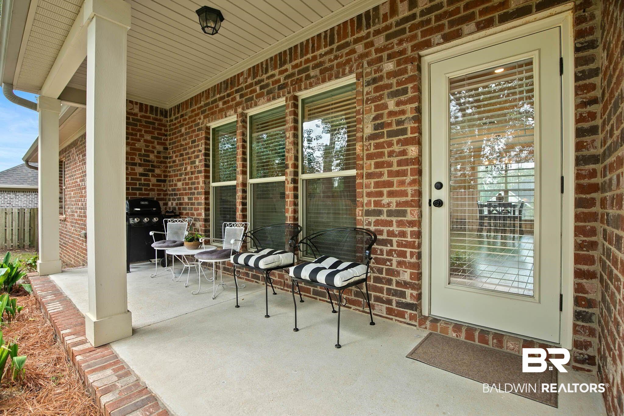 19740 Bunker Loop Fairhope, AL 36532 - Photo 31 of 33 Entrance to property featuring brick siding and covered porch
