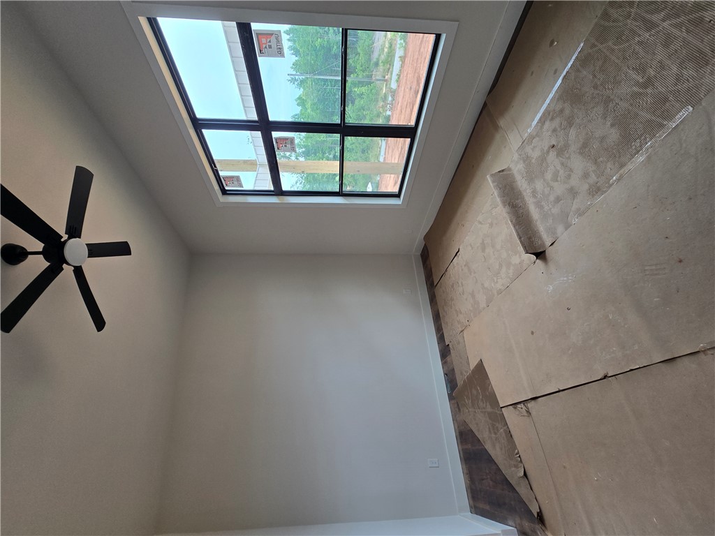 157 Hunting Hollow Road Six Mile, SC 29682 - Photo 10 of 19 Natural illumination fills this room, complemented by a sleek ceiling fan and expansive window views.
