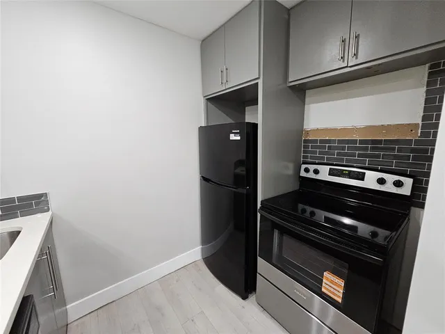a view of a stove and storage in a room