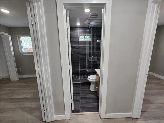 a view of bathroom with a shower and a sink