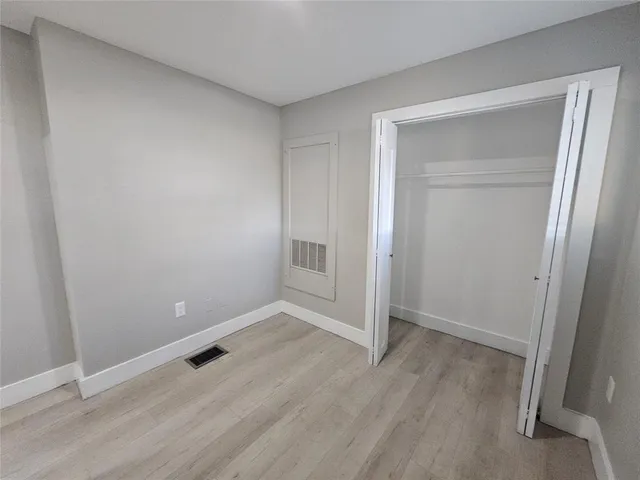 a view of an empty room with closet and closet