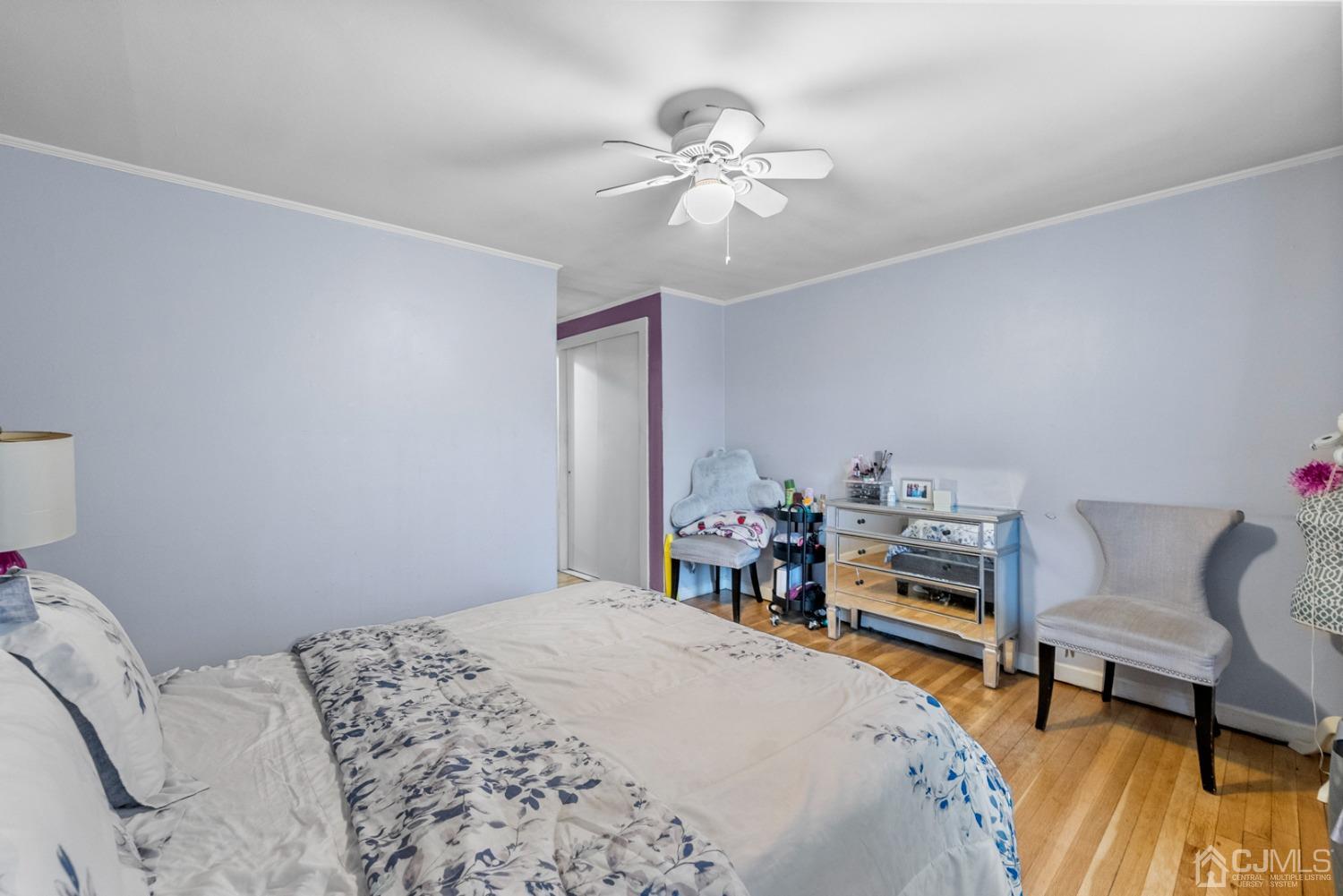 22B Garfield Park, Unit A Edison, NJ 08837 - Photo 19 of 36 a bedroom with a bed and a chandelier