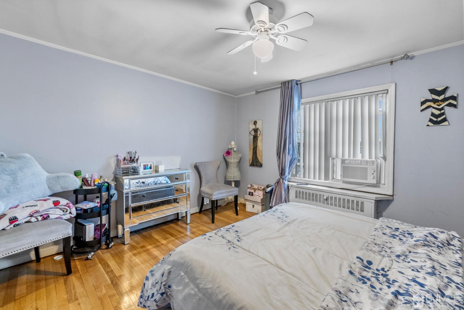 22B Garfield Park, Unit A Edison, NJ 08837 - Photo 20 of 36 a bedroom with a bed and a chandelier