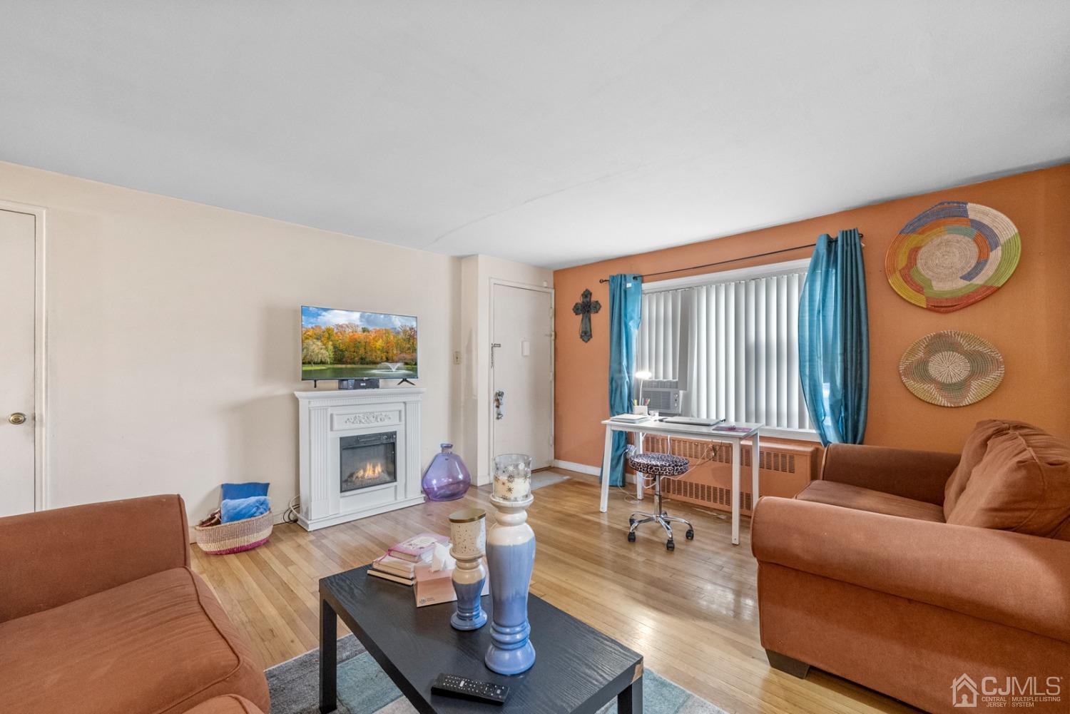 22B Garfield Park, Unit A Edison, NJ 08837 - Photo 5 of 36 a living room with furniture a fireplace and a window