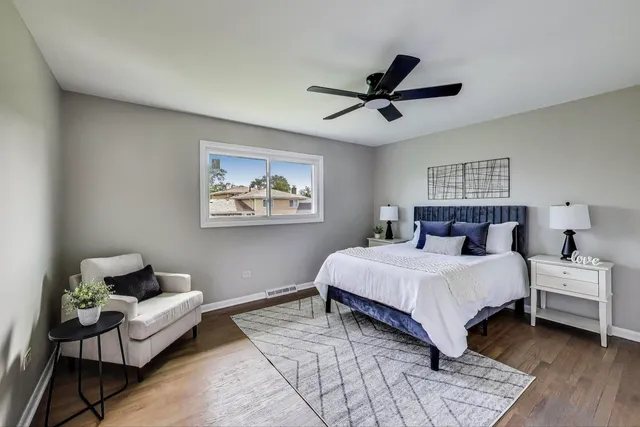 a spacious bedroom with a bed couch and a window