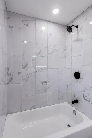 a bathroom with a bathtub and a shower