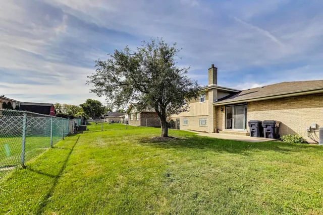 a house view with a sitting space and garden