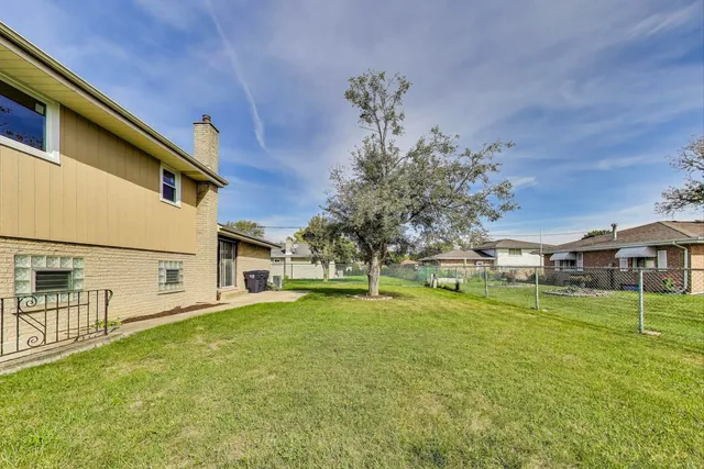 a swimming pool with outdoor seating and yard