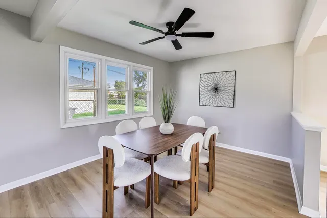 a view of a dining room with furniture window and wooden floor
