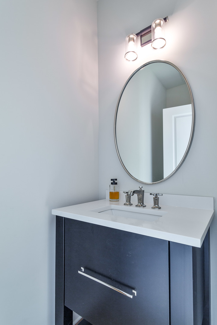 1263 Shermer Road Northbrook, IL 60062 - Photo 14 of 33 a bathroom with a sink and a mirror