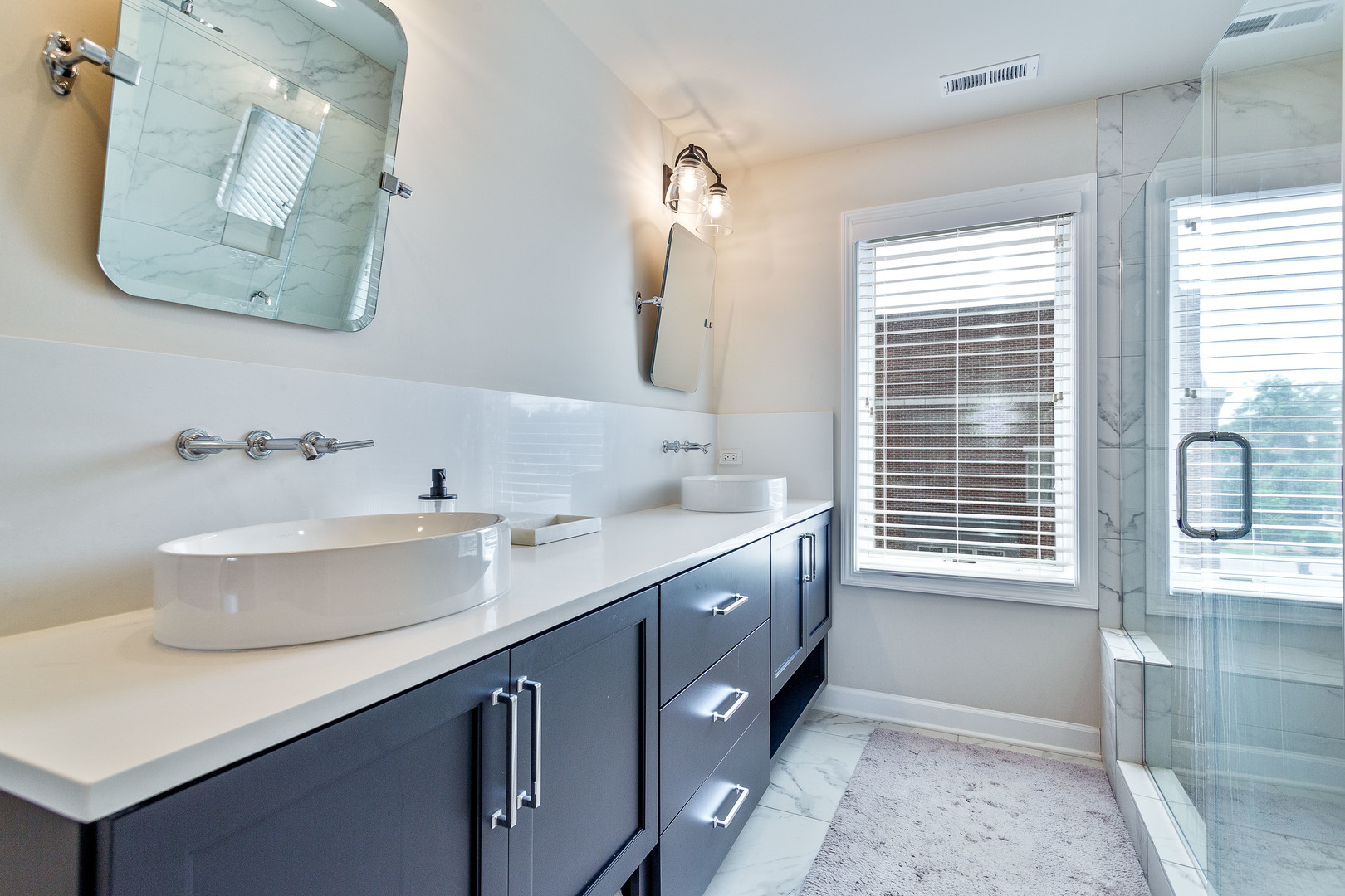 1263 Shermer Road Northbrook, IL 60062 - Photo 21 of 33 a bathroom with a double vanity sink window and mirror