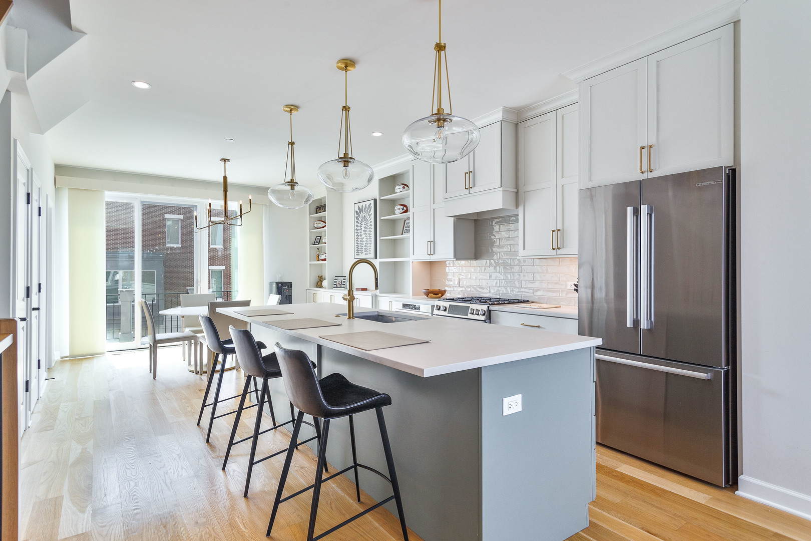 1263 Shermer Road Northbrook, IL 60062 - Photo 6 of 33 a kitchen with stainless steel appliances a dining table chairs refrigerator and sink