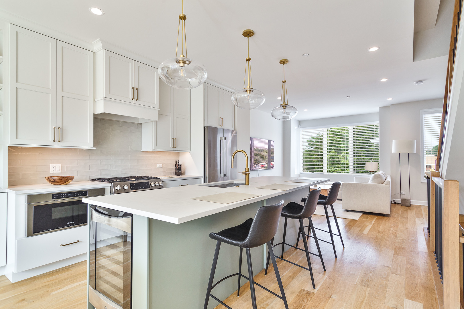 1263 Shermer Road Northbrook, IL 60062 - Photo 9 of 33 a kitchen with stainless steel appliances granite countertop a stove a refrigerator a kitchen island a sink dishwasher and white cabinets with wooden floor
