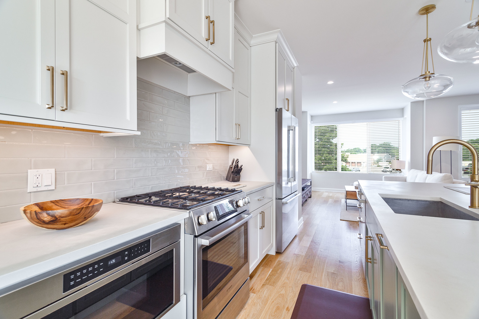 1263 Shermer Road Northbrook, IL 60062 - Photo 10 of 33 a kitchen with stainless steel appliances a stove a sink dishwasher and cabinets with wooden floor