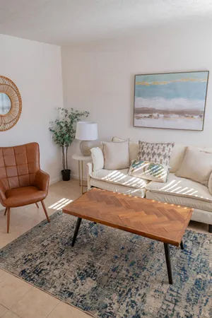 a living room with furniture and a potted plant