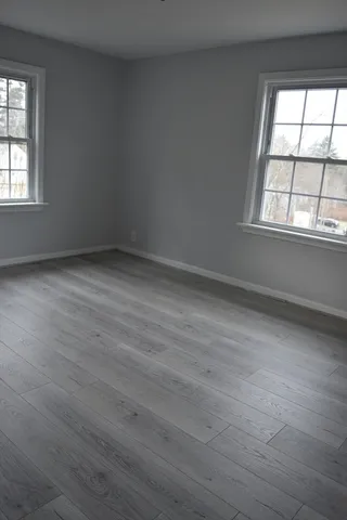 a view of hallway with wooden floor