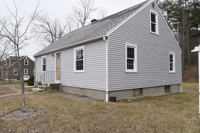 a view of a wooden house with a yard