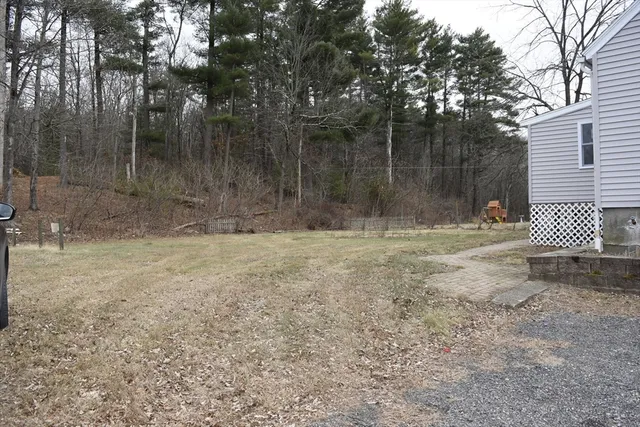 a kitchen with stainless steel appliances granite countertop a stove a sink dishwasher and a microwave oven with wooden floor