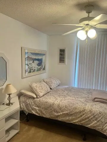 a bedroom with a bed and cabinets