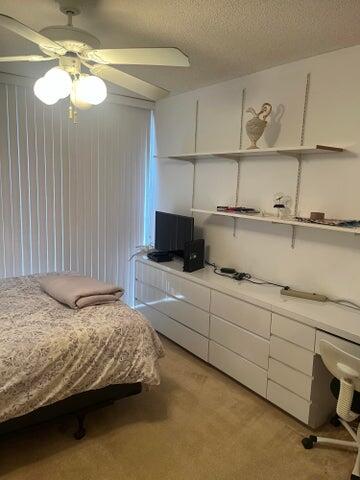 4746 South Ocean Boulevard, Unit 3 Highland Beach, FL 33487 - Photo 6 of 8 a bedroom with a bed and cabinets