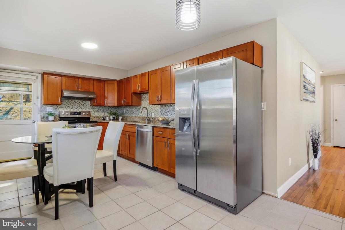 1021 Brice Road Rockville, MD 20852 - Photo 13 of 44 a kitchen with stainless steel appliances granite countertop a refrigerator and a stove top oven