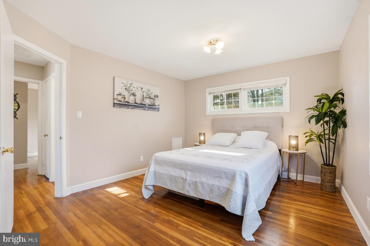 1021 Brice Road Rockville, MD 20852 - Photo 21 of 44 a bedroom with a bed and a potted plant