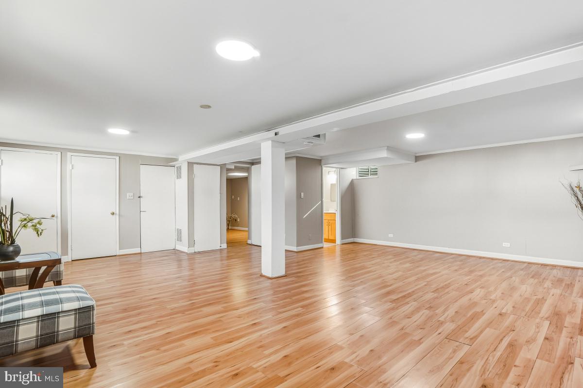1021 Brice Road Rockville, MD 20852 - Photo 33 of 44 a view of an empty room with wooden floor and a window