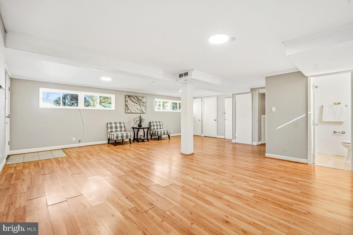 1021 Brice Road Rockville, MD 20852 - Photo 34 of 44 a view of an empty room with wooden floor and a window