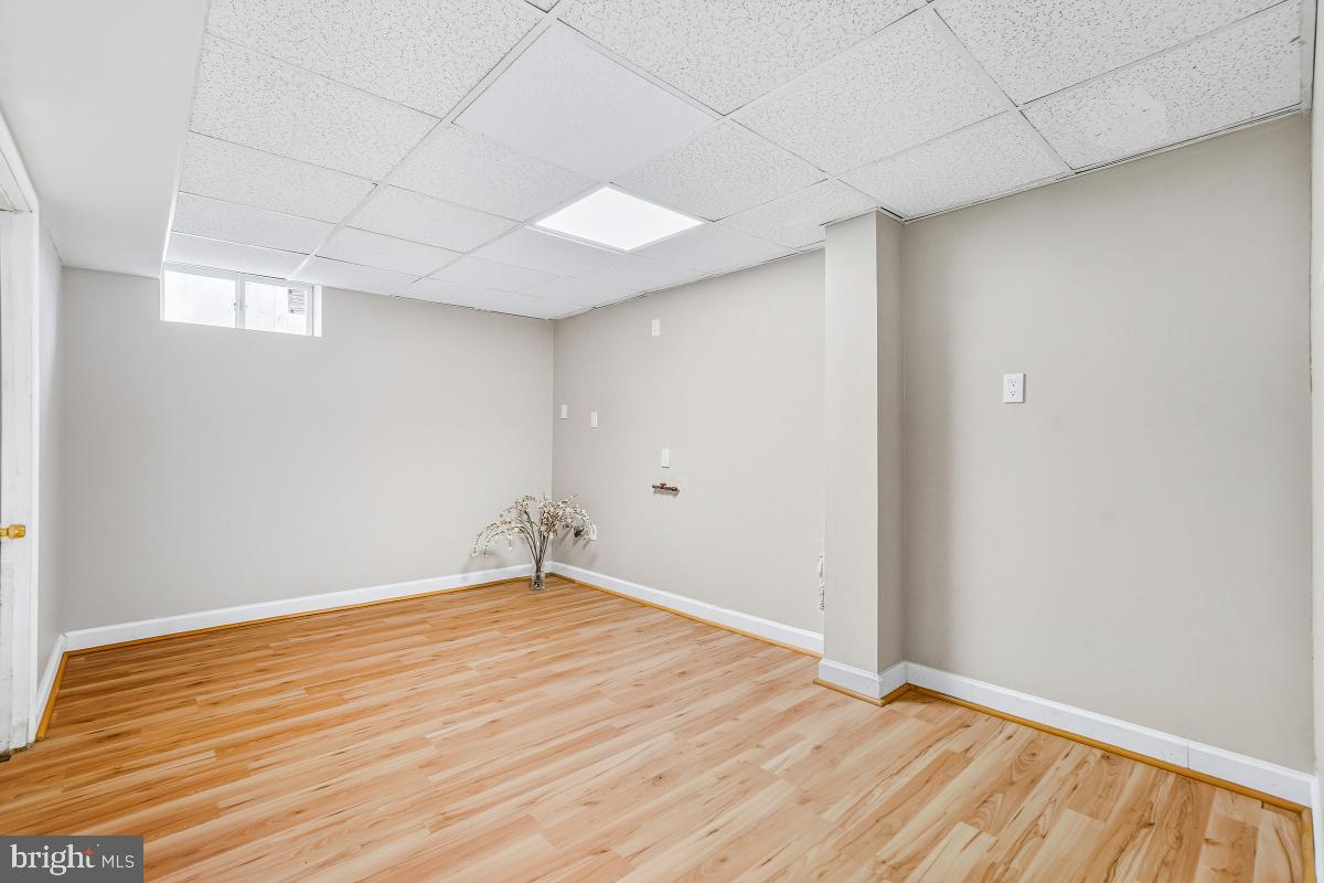 1021 Brice Road Rockville, MD 20852 - Photo 39 of 44 a view of an empty room with wooden floor