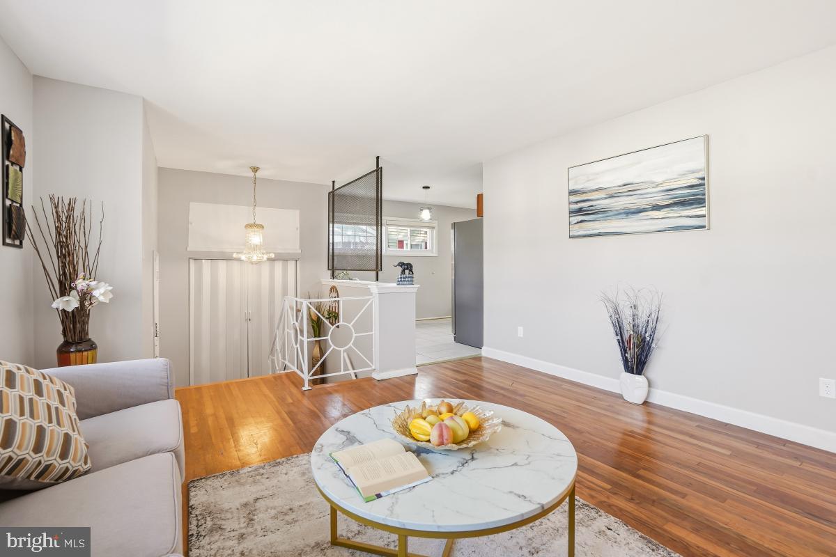 1021 Brice Road Rockville, MD 20852 - Photo 8 of 44 a living room with furniture and a wooden floor