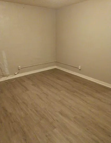 a view of a room with wooden floor