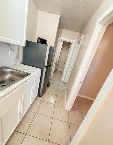 a kitchen with a cabinets and white appliances