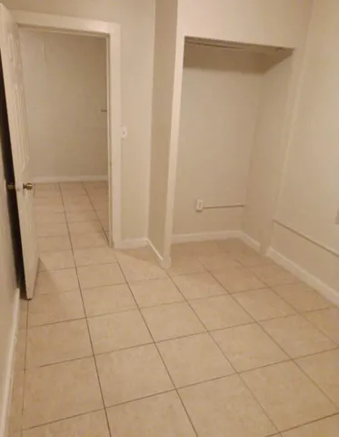 a white toilet sitting next to a shower