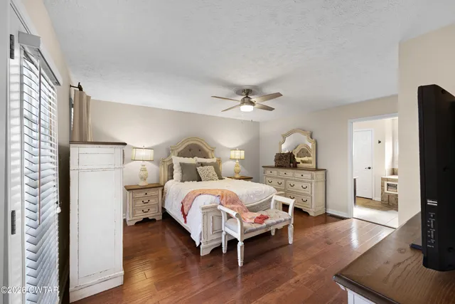 a living room with stainless steel appliances furniture a large window and a glass door