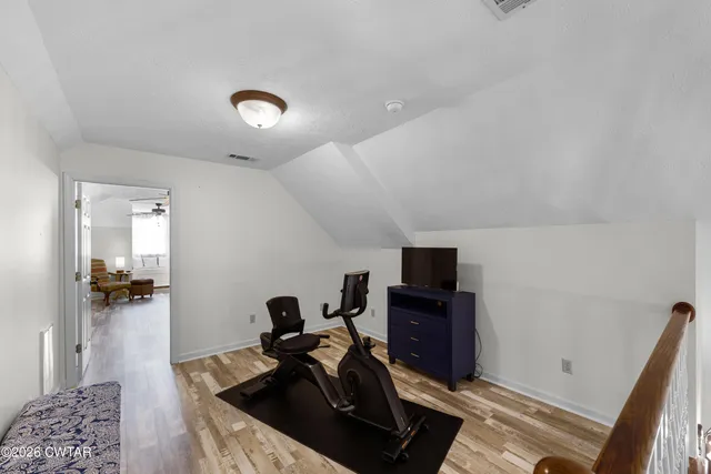 a view of a livingroom with furniture and a ceiling fan