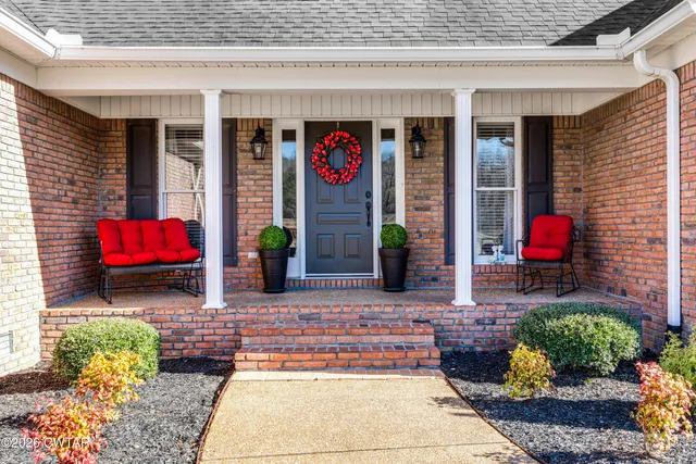 a front view of a house with a yard and outdoor seating