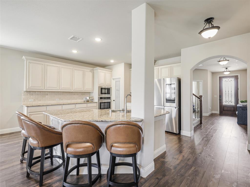1216 Tree Shadow Lane Anna, TX 75409 - Photo 8 of 37 a kitchen with sink and refrigerator