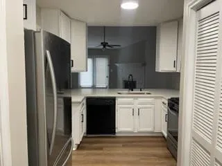 a kitchen with a refrigerator and a sink